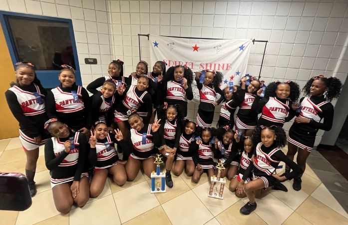  cheer team with trophies